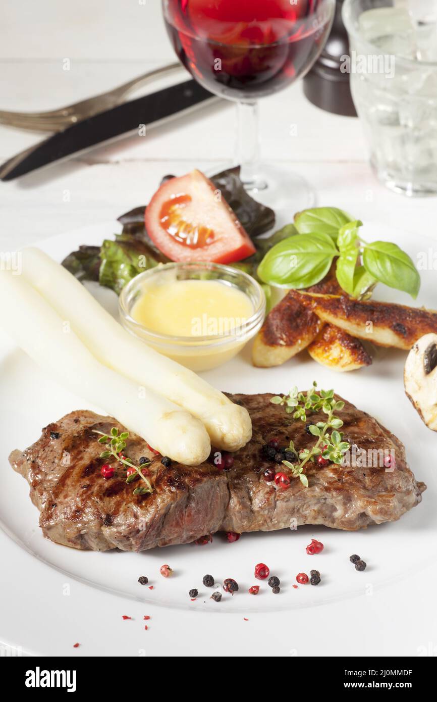 White asparagus on a grilled steak Stock Photo