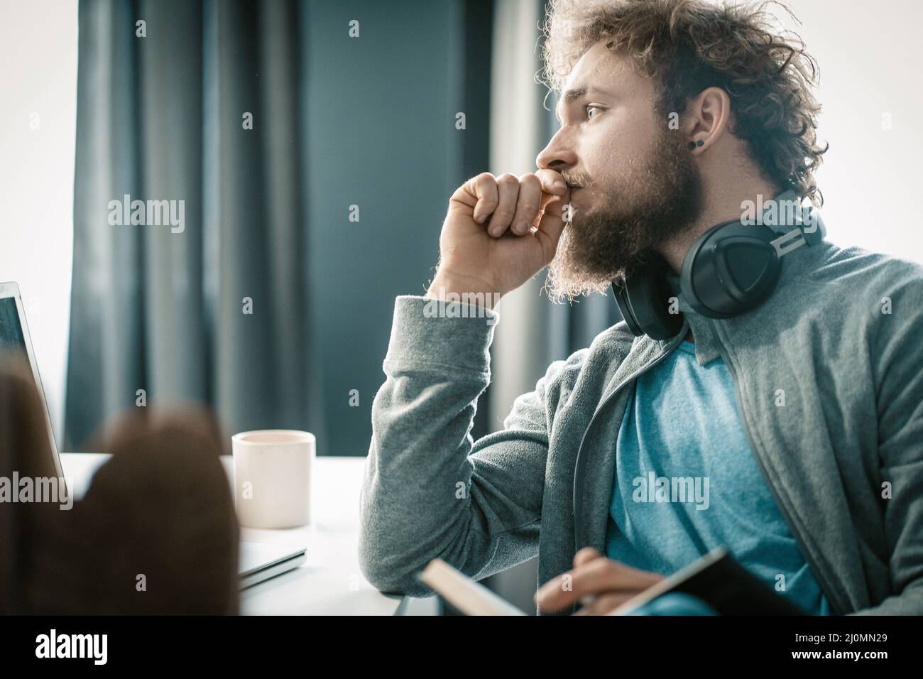 Pensive Man is Thinking How to Organize His Business Process During the Quarantine Period. A Man is Sad About His Problems in Li Stock Photo