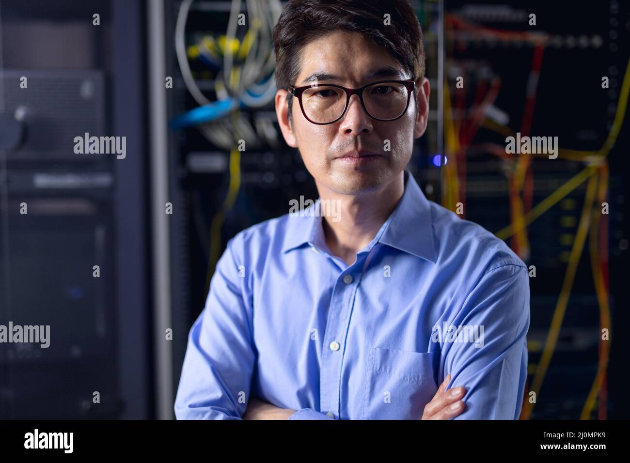Portrait of asian male engineer with arms crossed in computer server ...