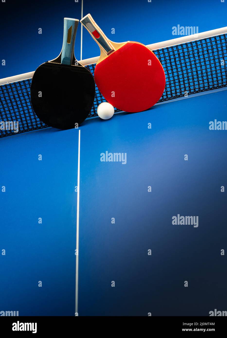 Two Table Tennis Rackets Two table tennis rackets and balls on a blue table with net Stock Photo ...