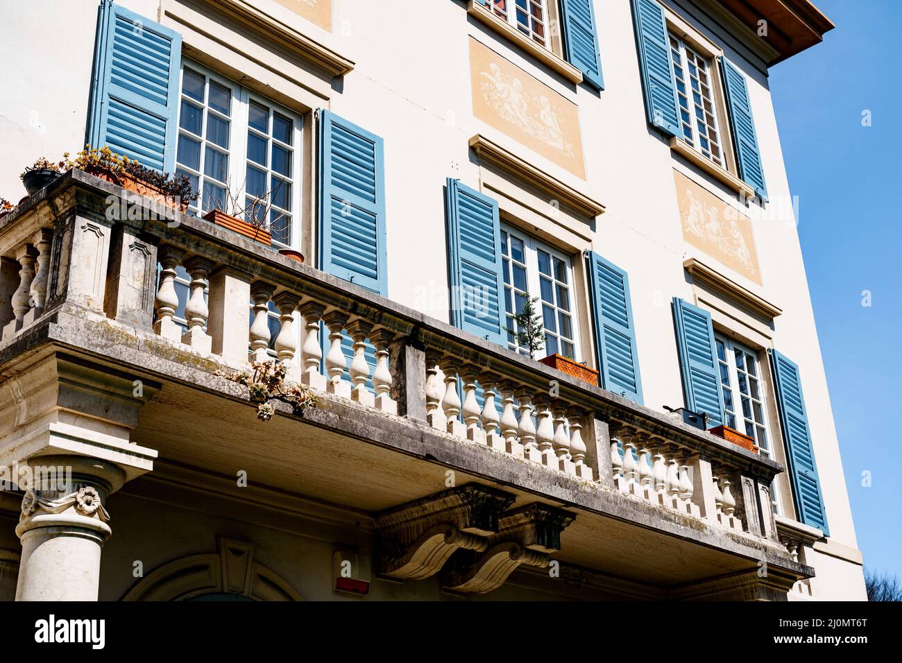 Stone balcony on the facade of the Church of San Lorenzo. Lake Como, Italy Stock Photo