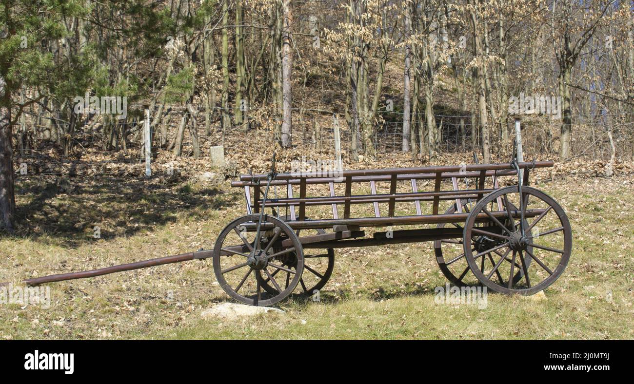 Old wooden carriage on four wheels. Antique vintage horse  four-wheeled cart. Stock Photo