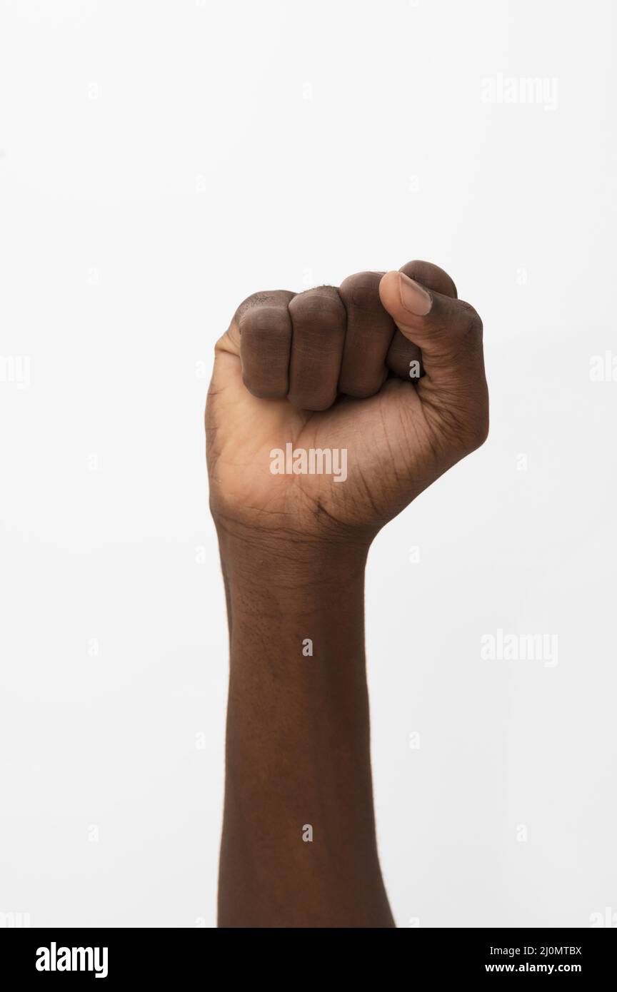 Black person holding their fist up Stock Photo Alamy