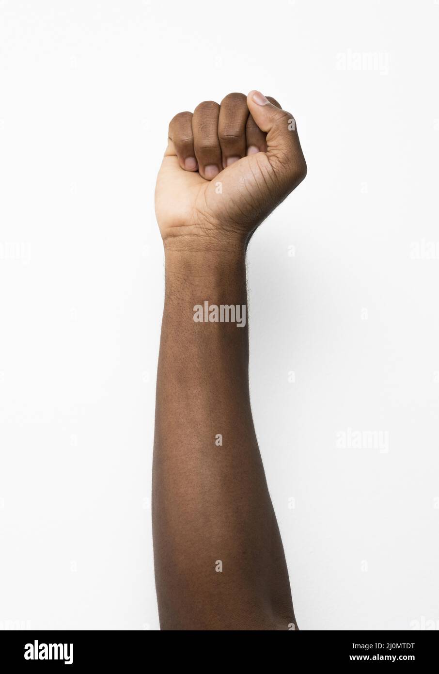 Black person holding fist up Stock Photo