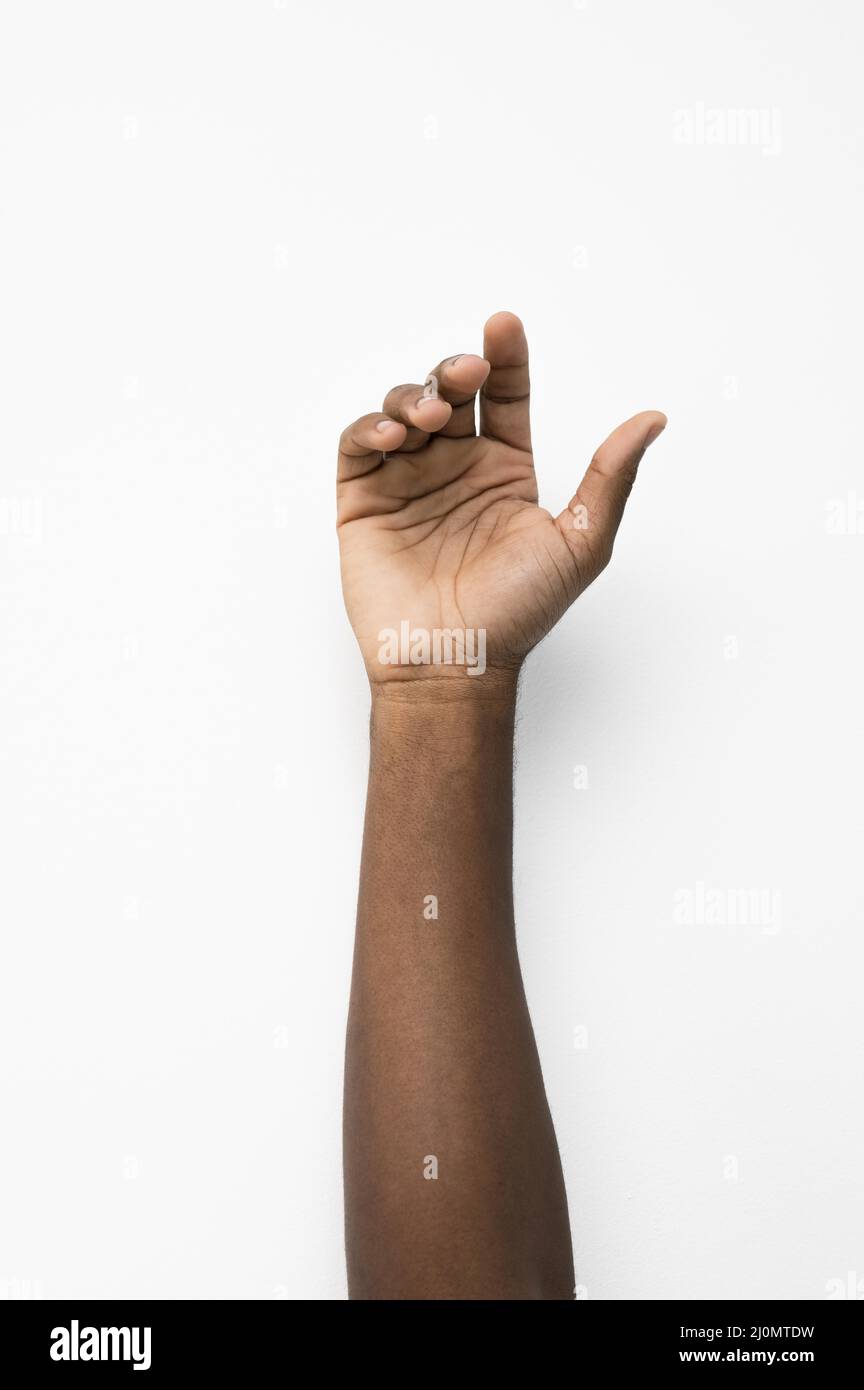 Black person holding their hand up Stock Photo