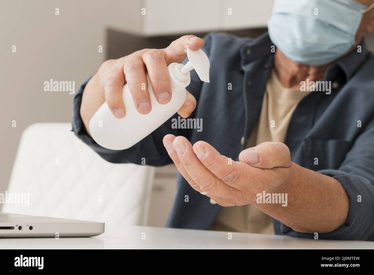 Close up man using disinfectant Stock Photo