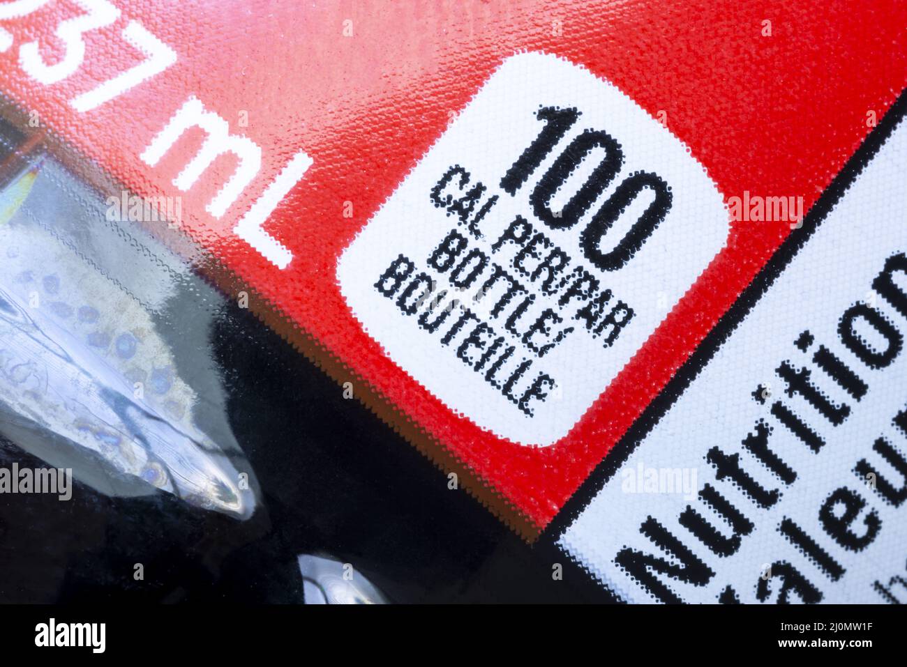 A close up to a regular soft drink drink bottle to calories amount