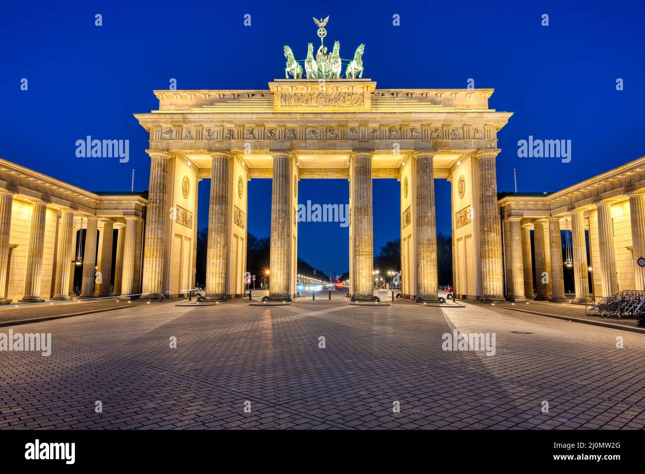 The famous illuminated Brandenburg Gate in Berlin at twilight Stock Photo