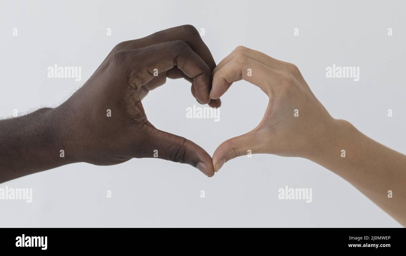 Black white hands making heart shape Stock Photo