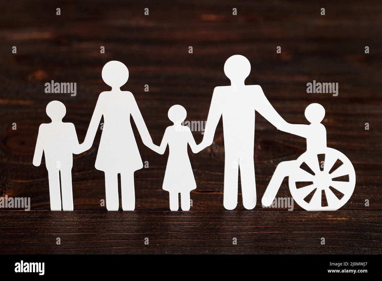 Cutout paper different family members wooden background Stock Photo