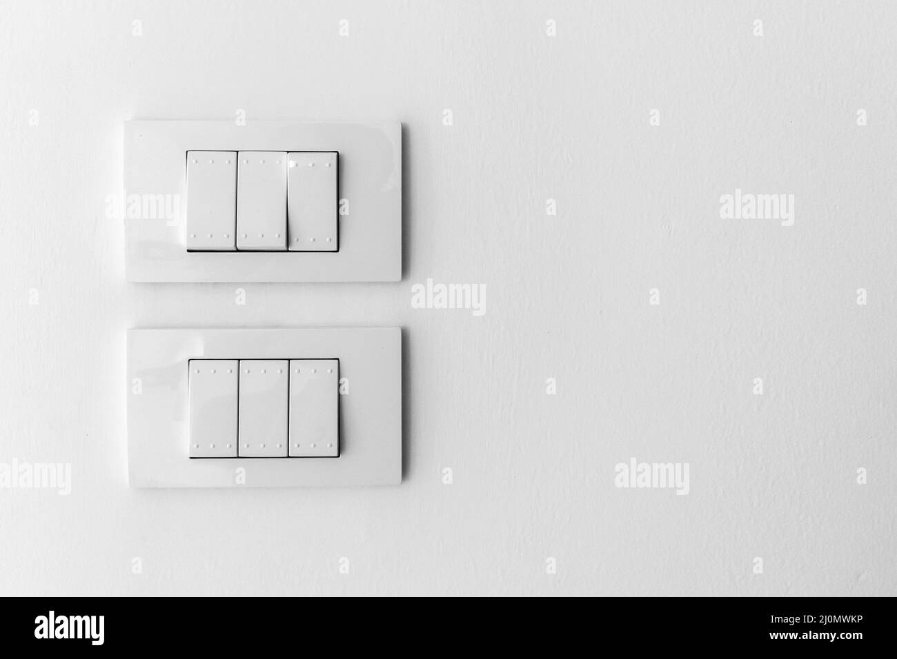 white lighting switch on concrete wall background Stock Photo