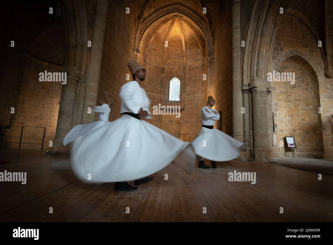 Group of Dervishes performing the traditional and religious whirling dance or Sufi whirling Stock Photo