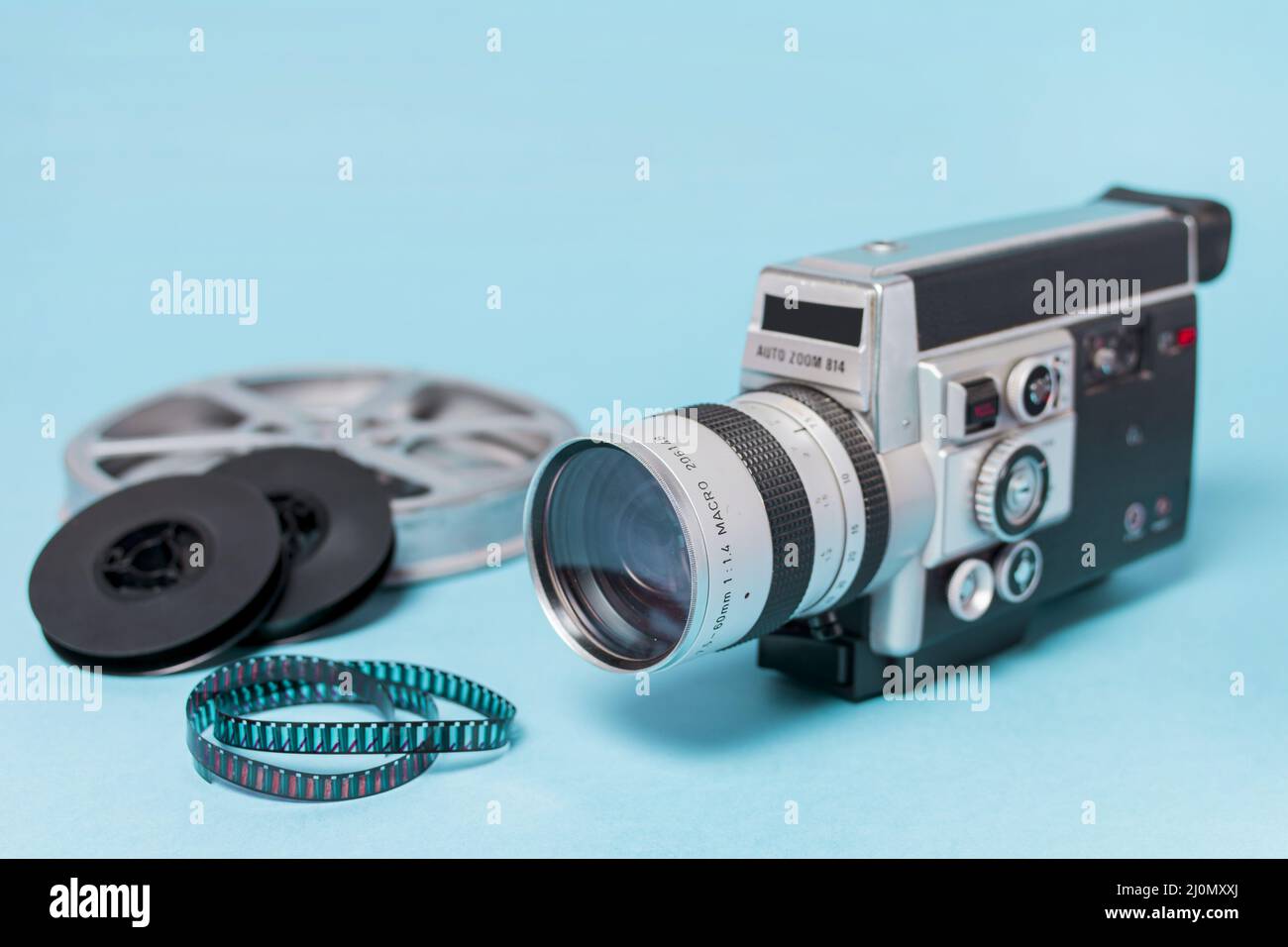 Film reels film strips vintage camcorder blue background Stock Photo