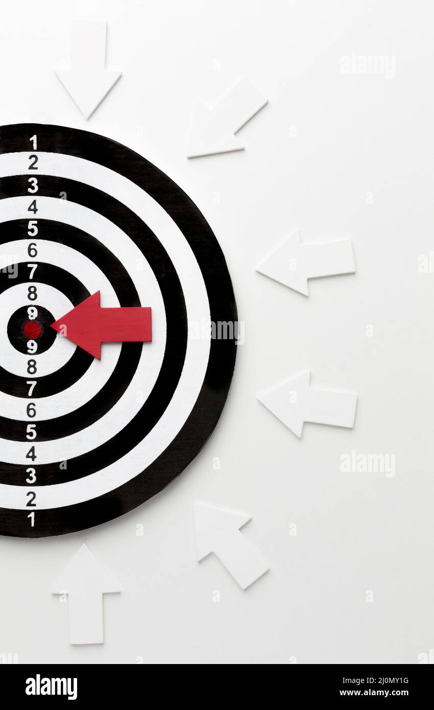 Flat lay target with arrows pointing bullseye Stock Photo