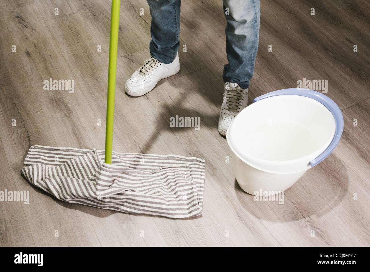 Close up man mopping floor Stock Photo