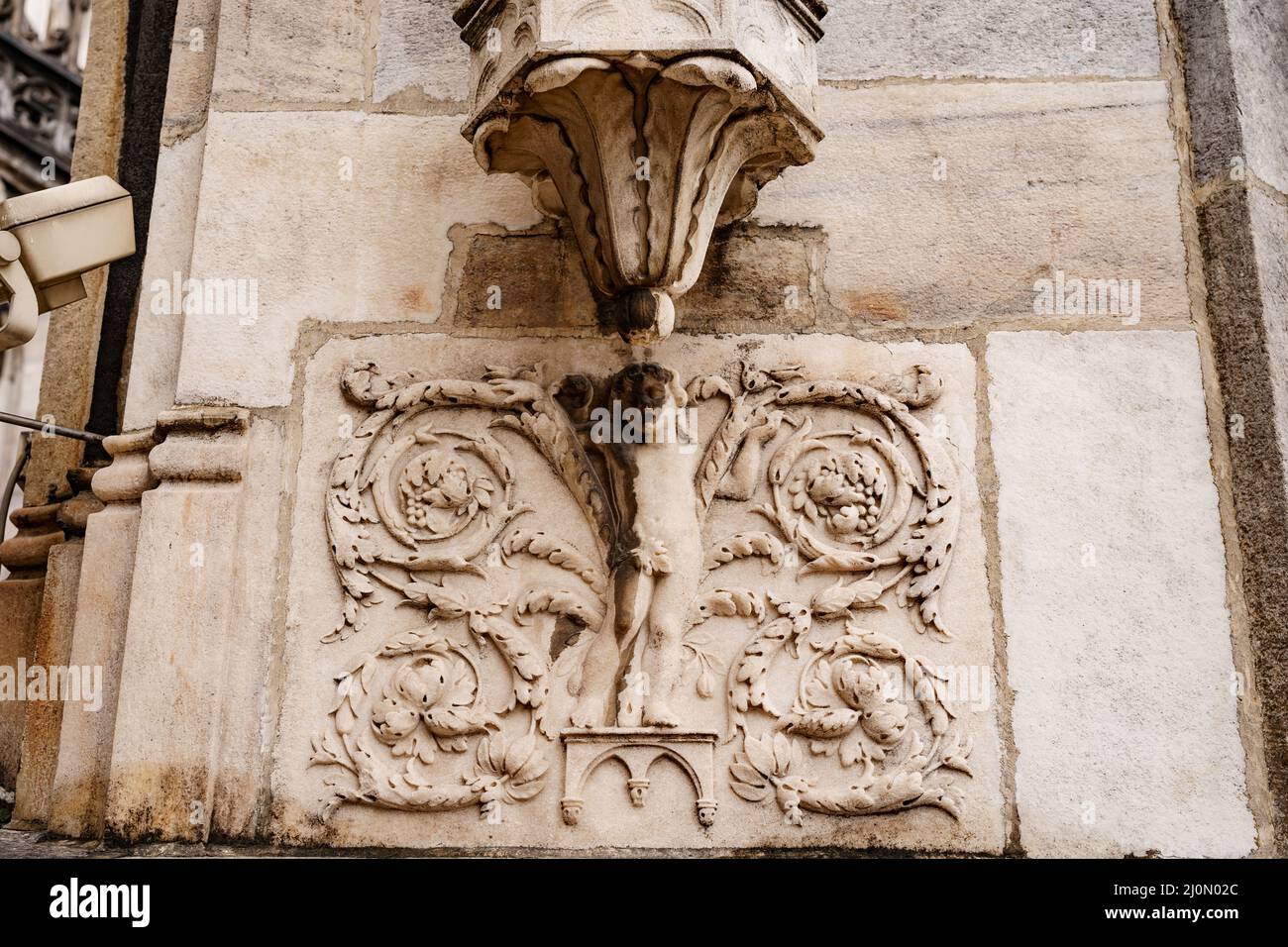 Boy with floral patterns on the stone slab of the Duomo facade. Milan, Italy Stock Photo