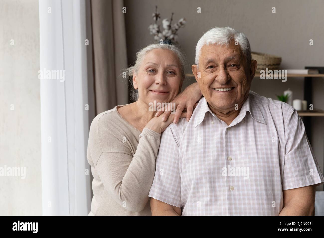 Portrait of older grandparents smile staring at camera feel happy Stock