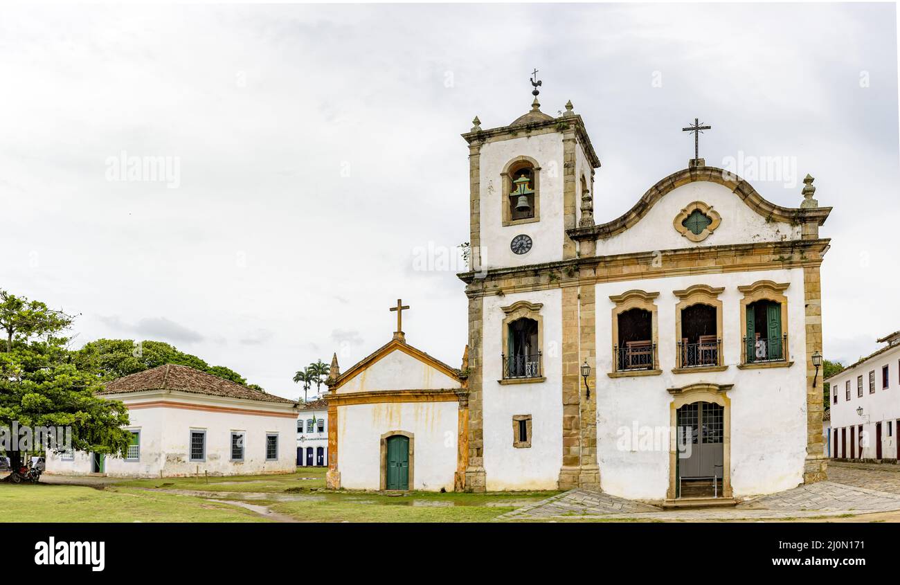 Historic church facade and surrounding houses in the ancient city of Paraty Stock Photo