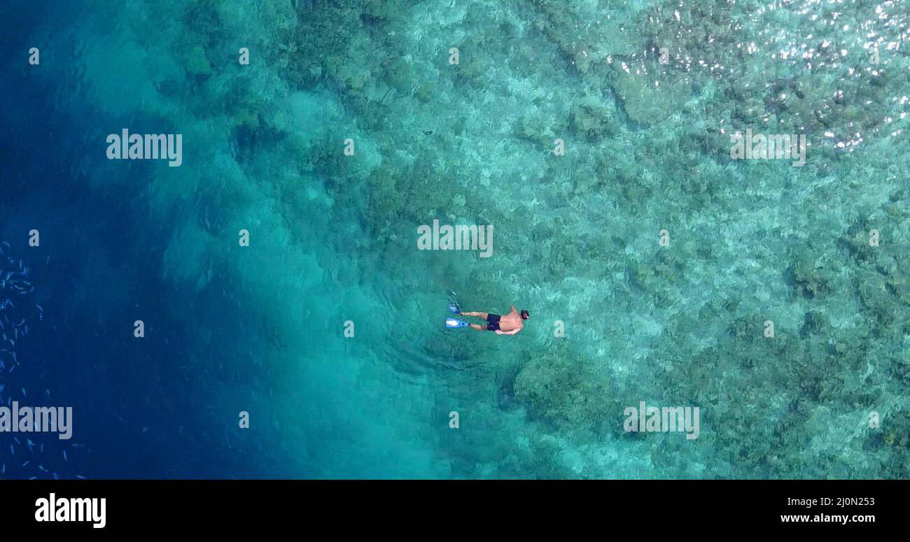 Aerial view of a swimming Caucasian couple in Rasdhoo Island, The ...