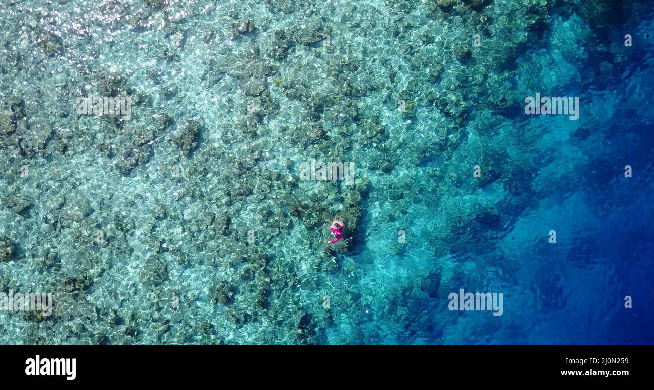 Aerial view of a swimming Caucasian couple in Rasdhoo Island, The ...