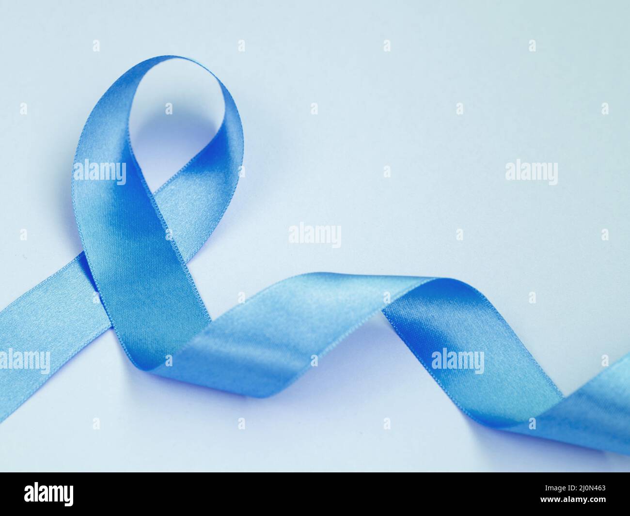 Above view cancer concept with blue ribbon Stock Photo