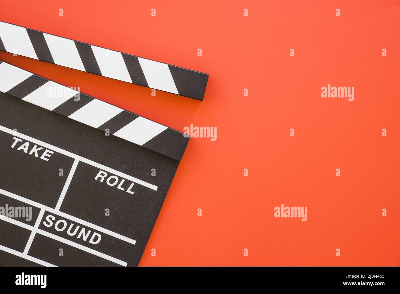 Clapperboard on red background with space Stock Photo