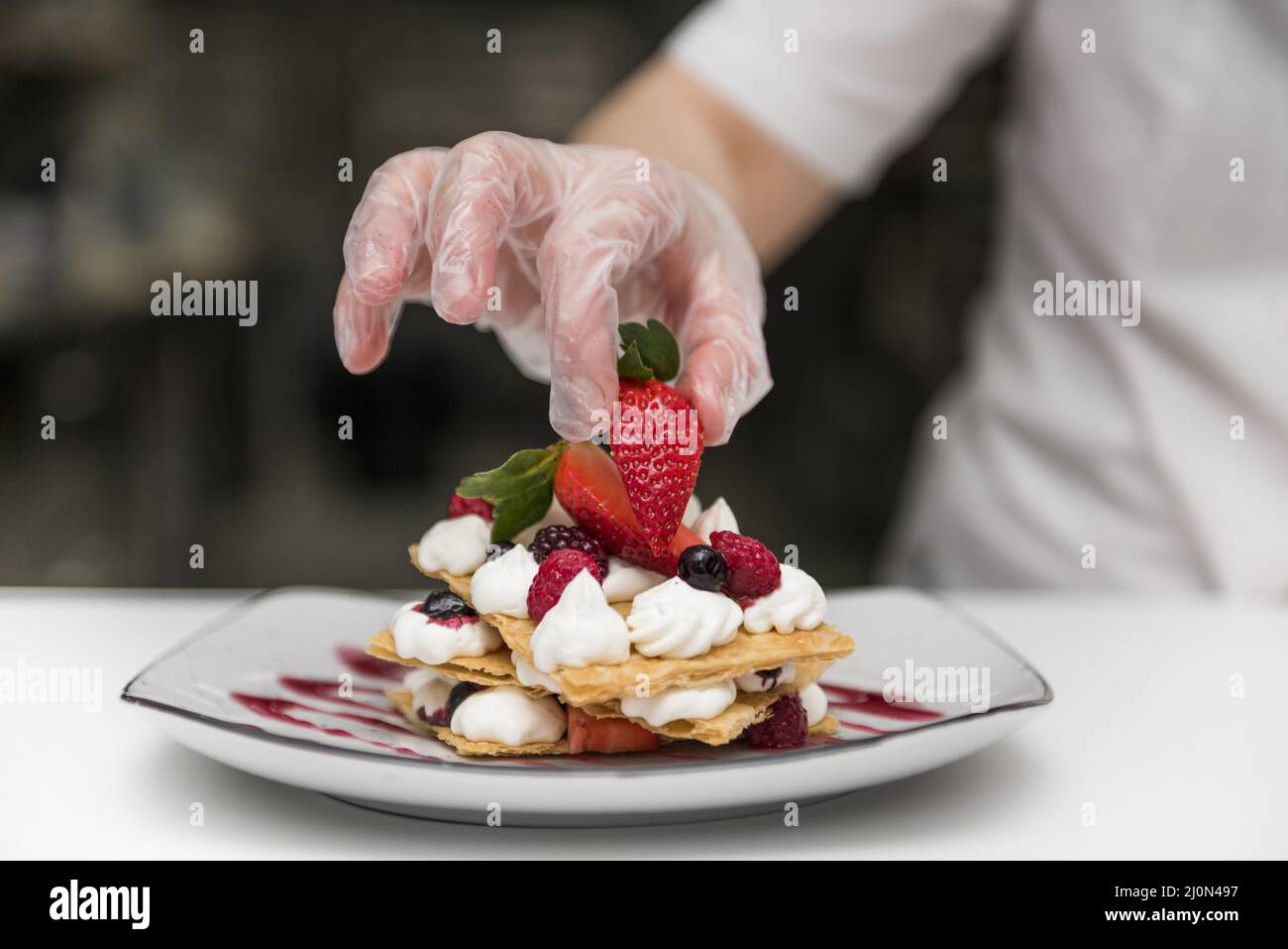 (1)chef putting strawberry dessert Stock Photo