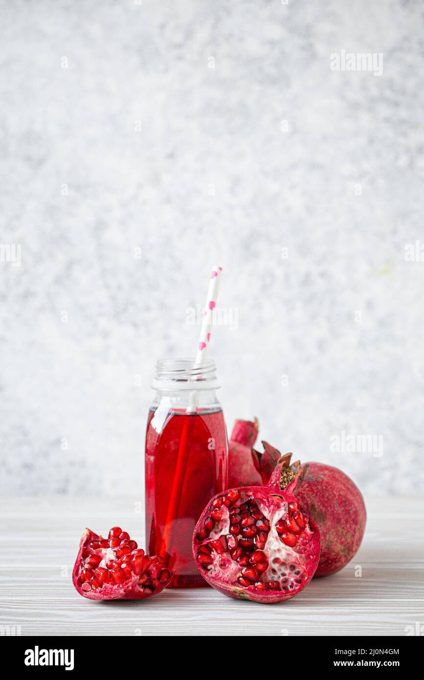 Pomegranate juice in bottle and fruit Stock Photo Alamy