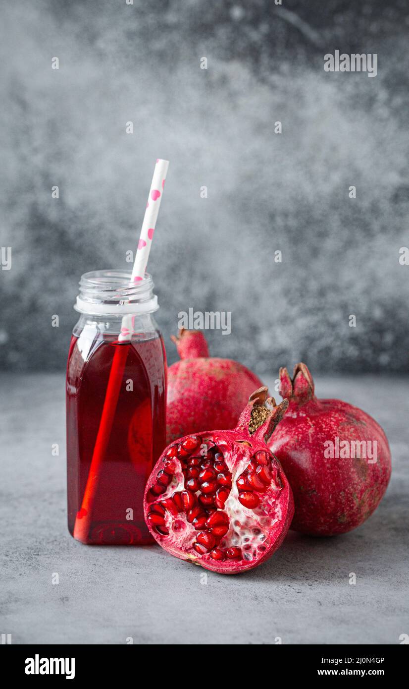 Pomegranate juice in bottle and fruit Stock Photo Alamy