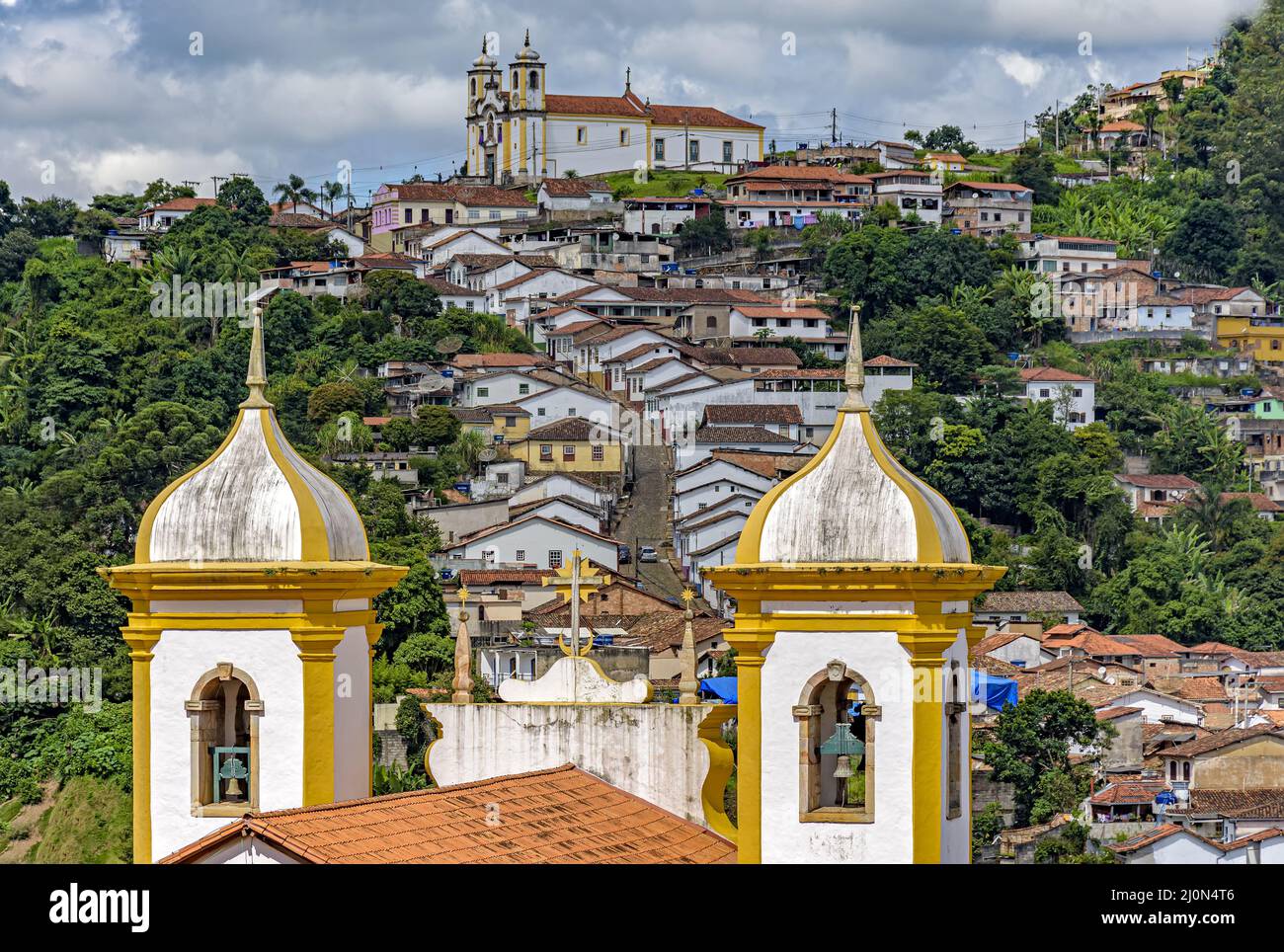 Ouro Preto city with its slopes, hills and churches seen through the old church towers Stock Photo