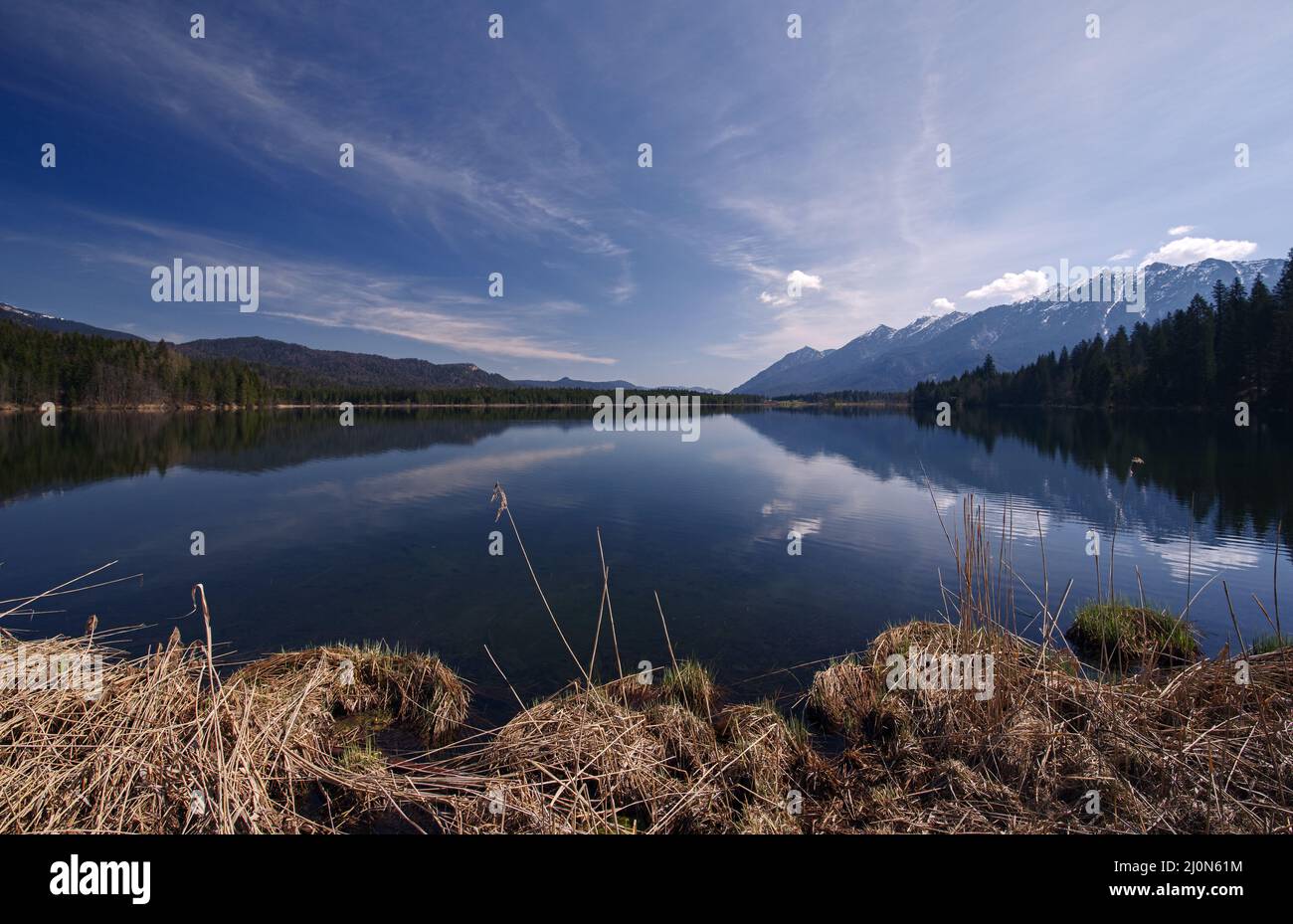 Early spring atmosphere at Lake Barmsee in the Bavarian Alps with view ...