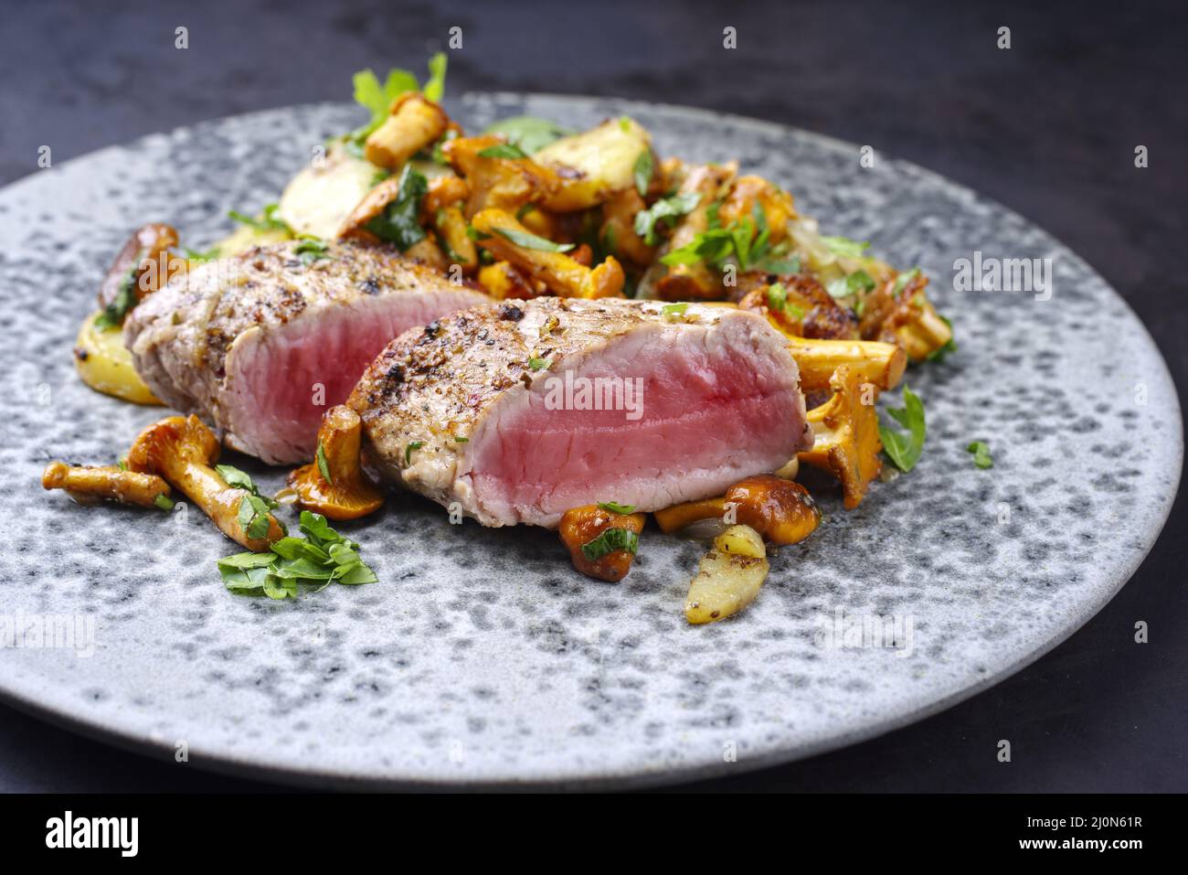 Modern style fried dry aged pork fillet chateaubriand medallion steak