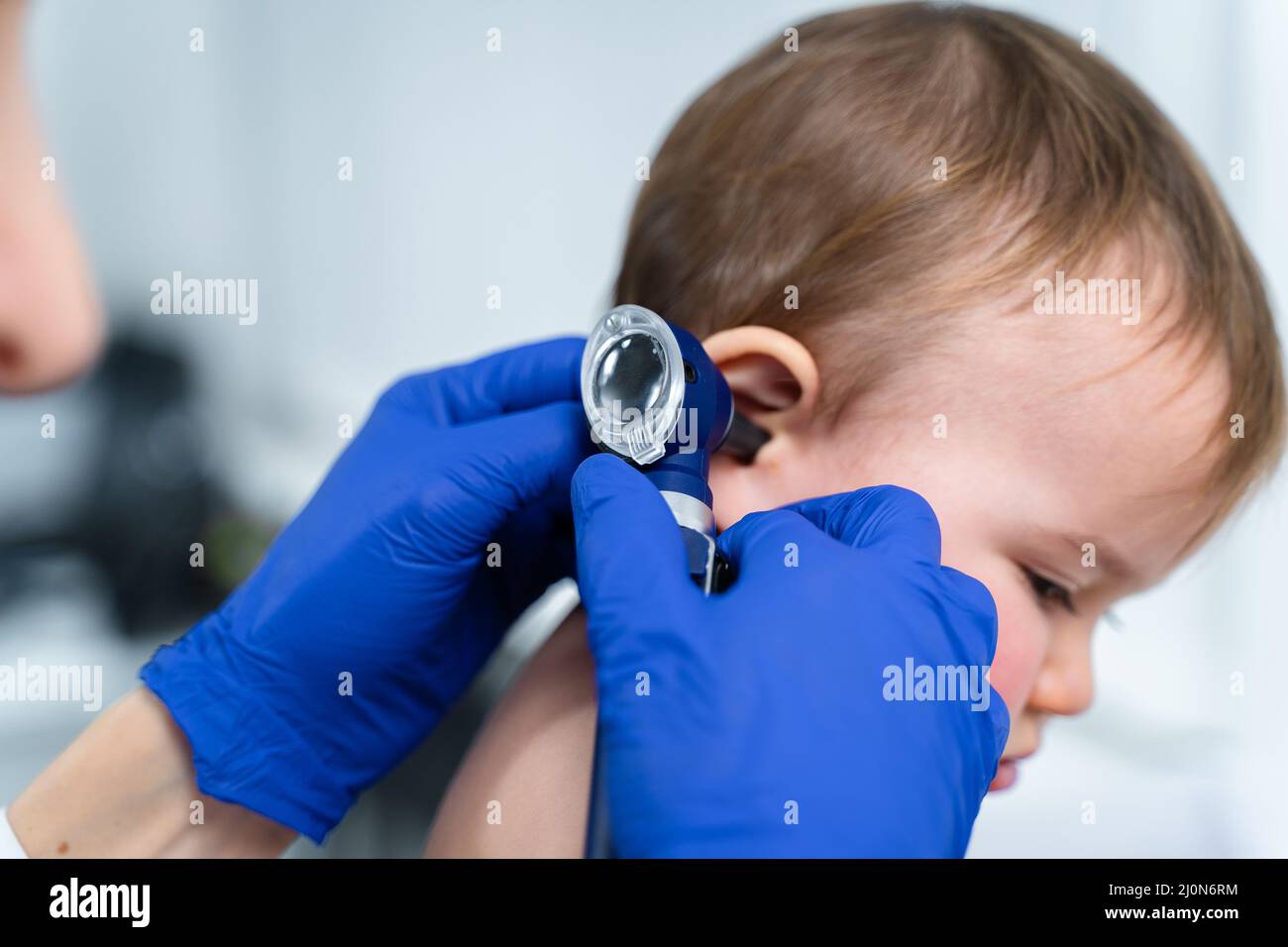 Pediatrician doctor concept. Children medical care. One year old baby girl examined by female pediatrician in clinic office. Chi Stock Photo