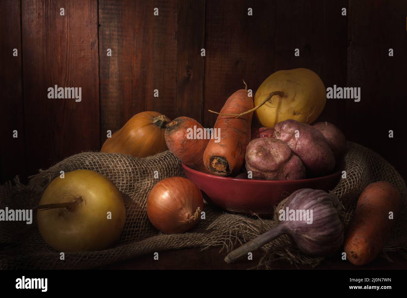 Vegetables in a clay bowl on a dark wooden background Stock Photo