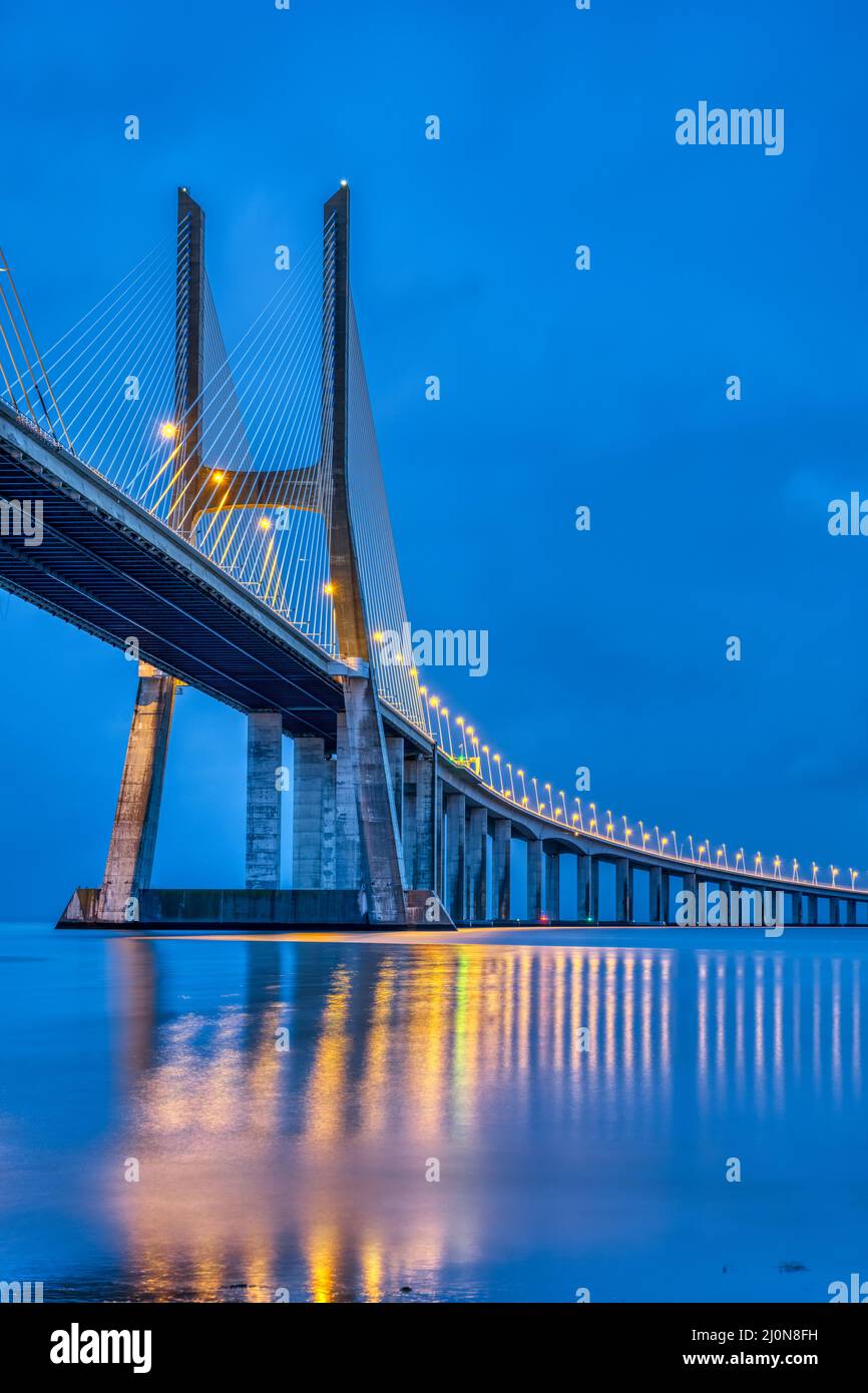 The cable-stayed Vasco da Gama bridge across the river Tagus in Lisbon, Portugal, at dusk Stock Photo