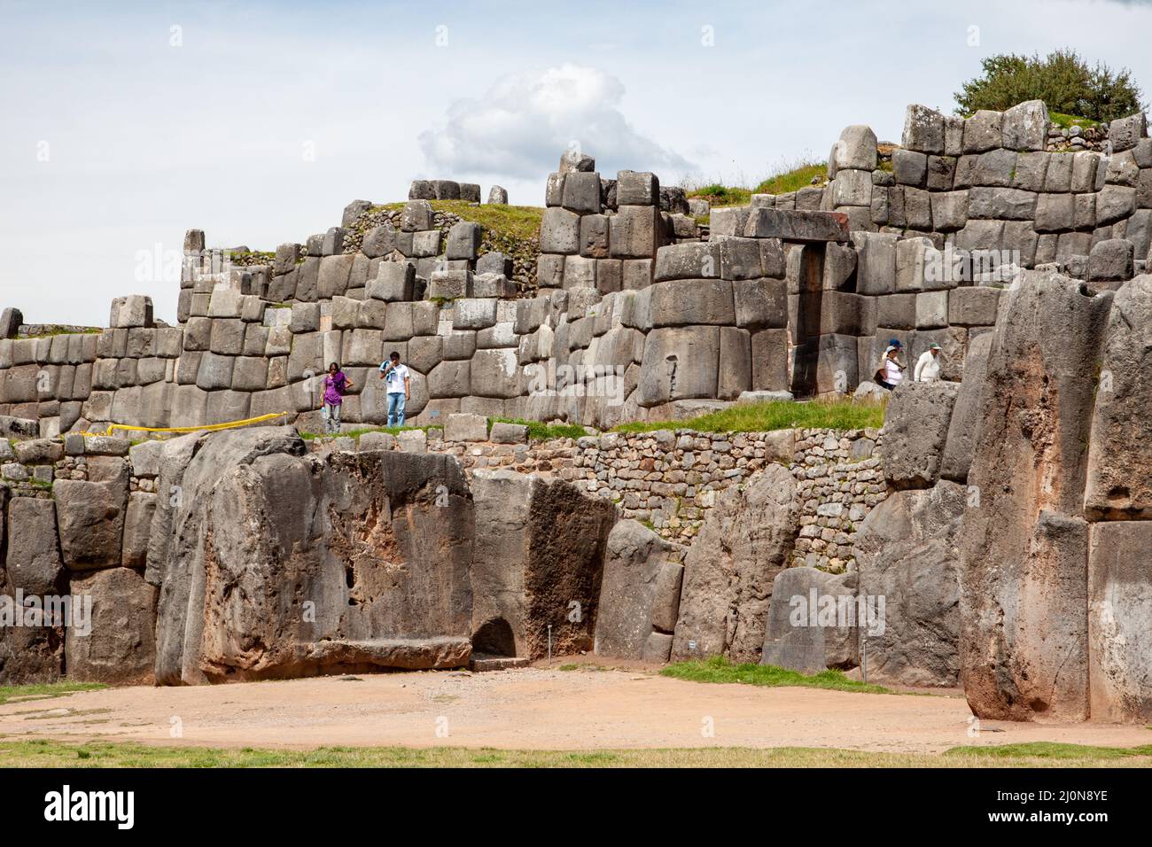A tourists Saqsaywaman Inca archaeological site with large stone walls