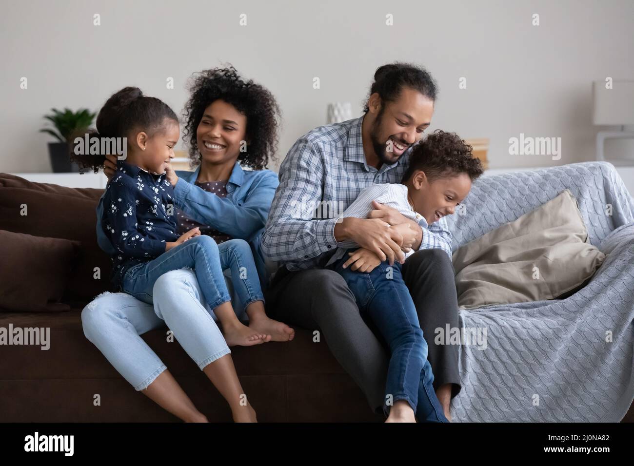 Positive cheerful Black mom and dad cuddling Stock Photo Alamy