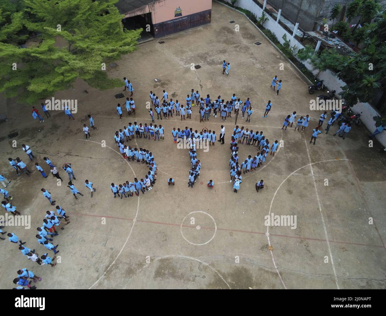 Aerial top view of the students of a high school forming the letters ...