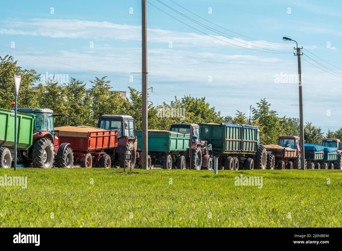 Tractors delivering recently harvested grain Stock Photo