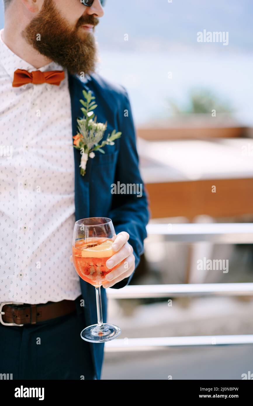 Bearded redhead groom with a glass in his hand Stock Photo