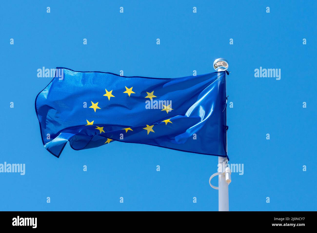 European union flag waving on a clear sky Stock Photo - Alamy