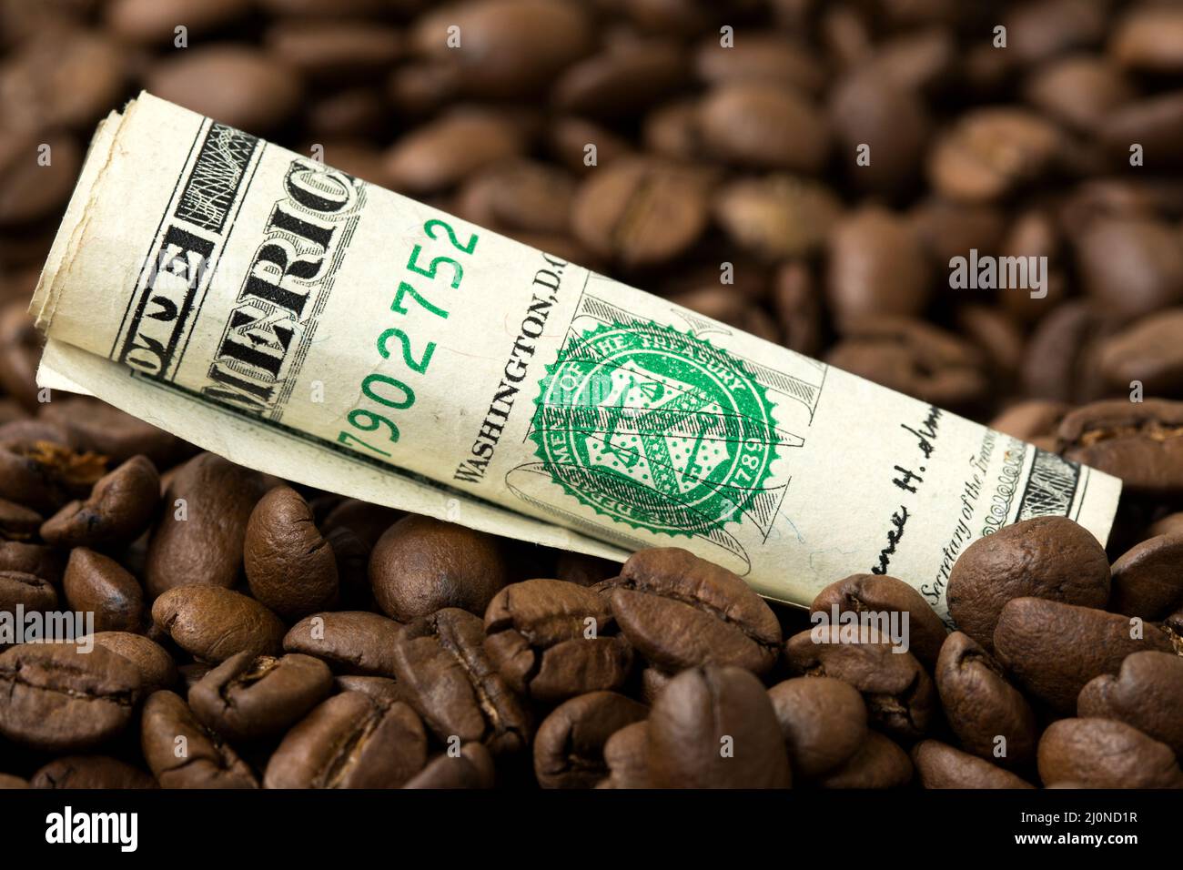 Roasted coffee beans and USD currency close-up Stock Photo
