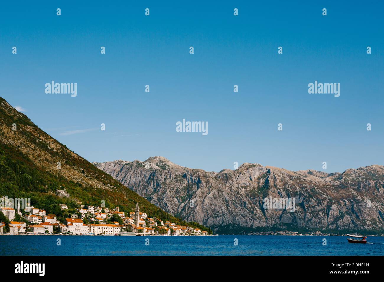 Town of Perast with old houses against the blue sky. Montenegro Stock Photo