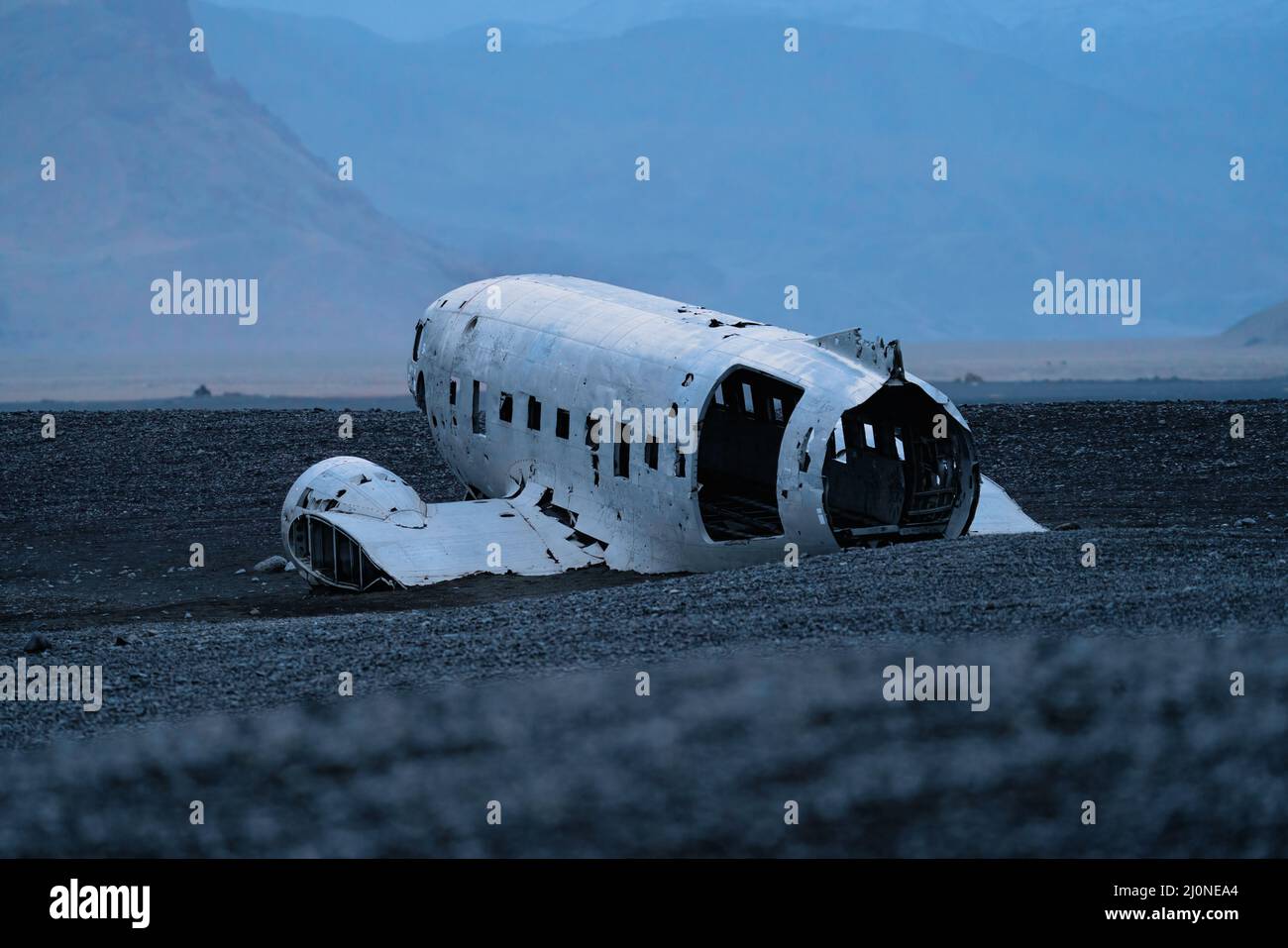 Wreck of airplane and mountains in the background Stock Photo