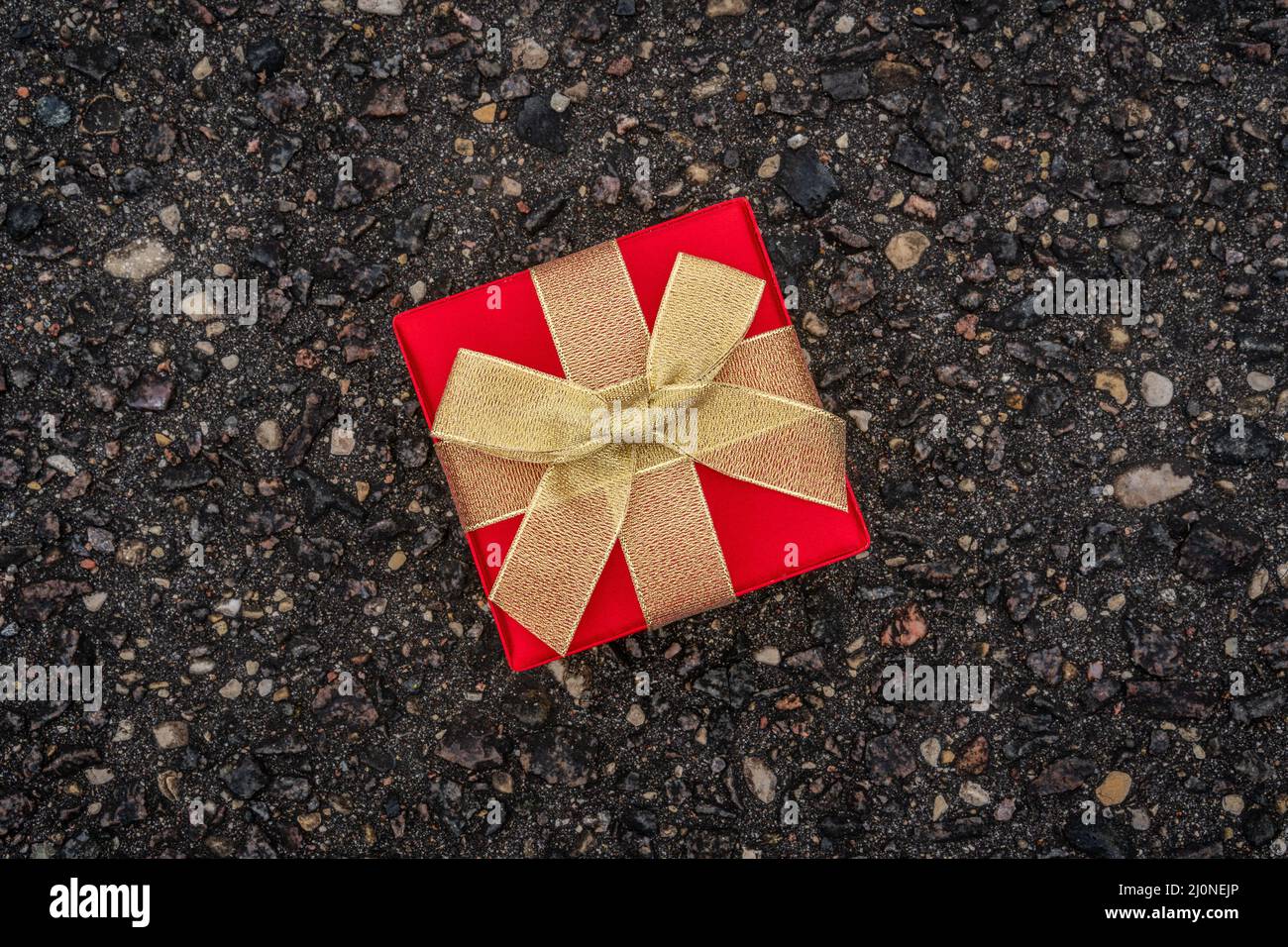 Gift box on the asphalt road Stock Photo - Alamy