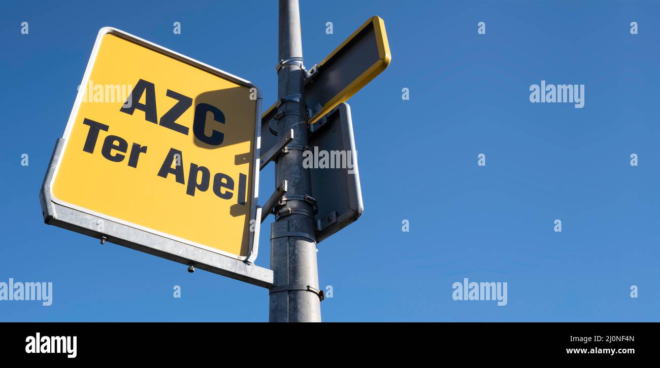 Sign at bus stop intended for refugees to the asylum seekers center Ter Apel at the bus and train station in Emmen, the Netherlands Stock Photo