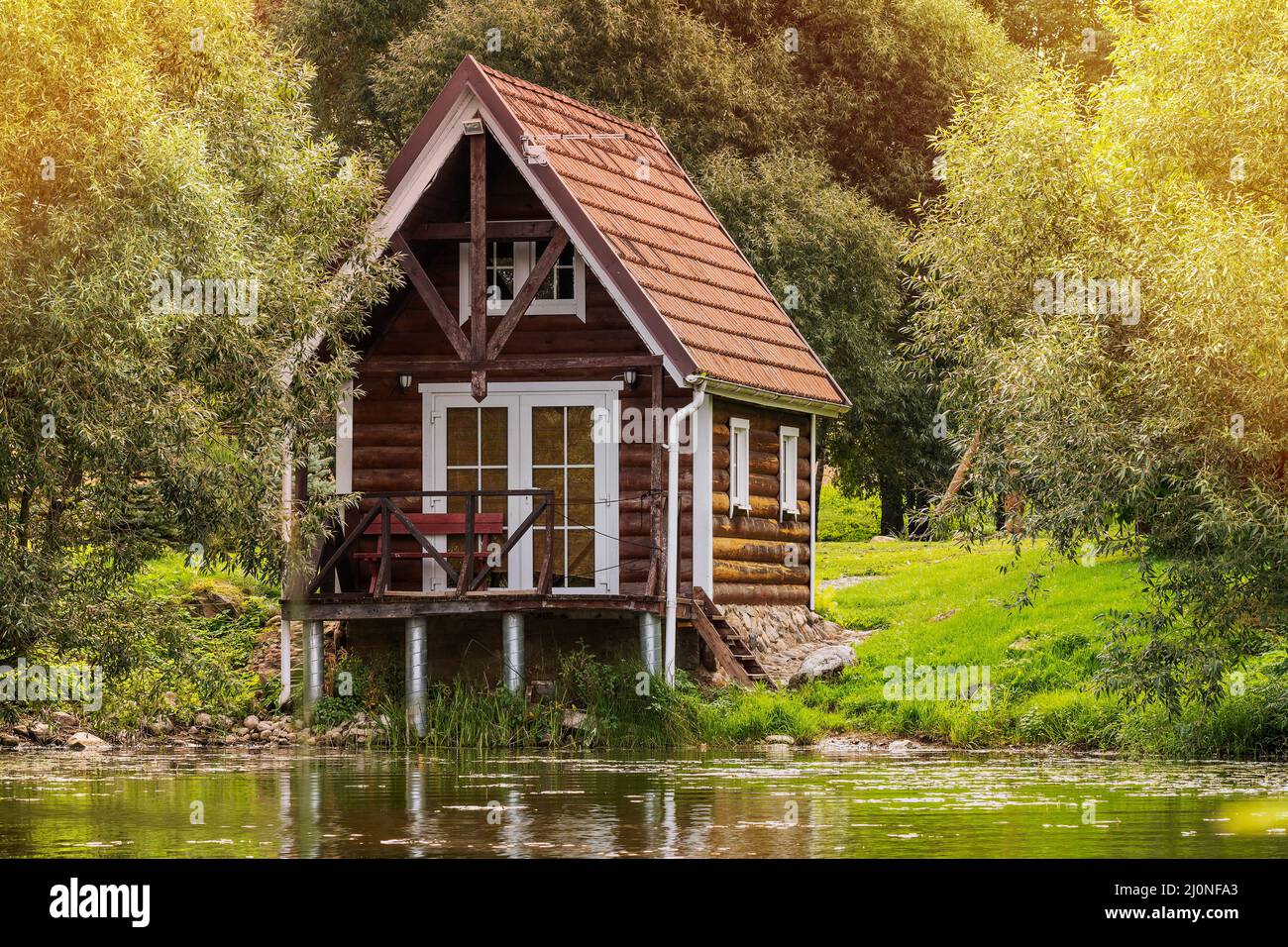 Small wooden house near the lake Stock Photo Alamy