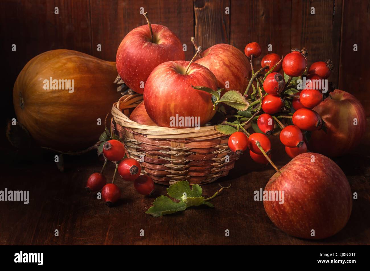 Apples and other fruits on a dark wooden background in a rustic style Stock Photo