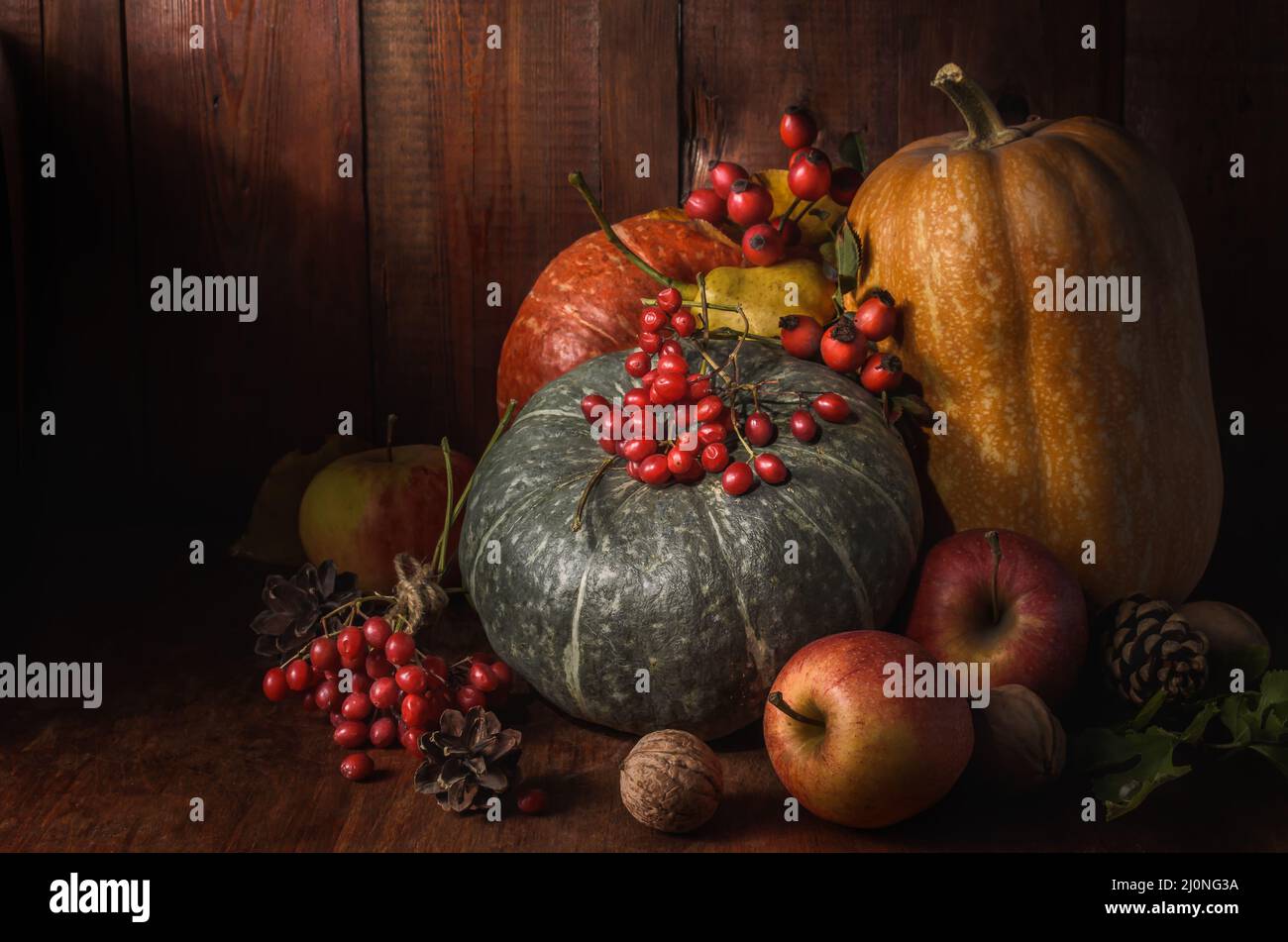 Pumpkin and other fruits on a dark wooden background in a rustic style Stock Photo