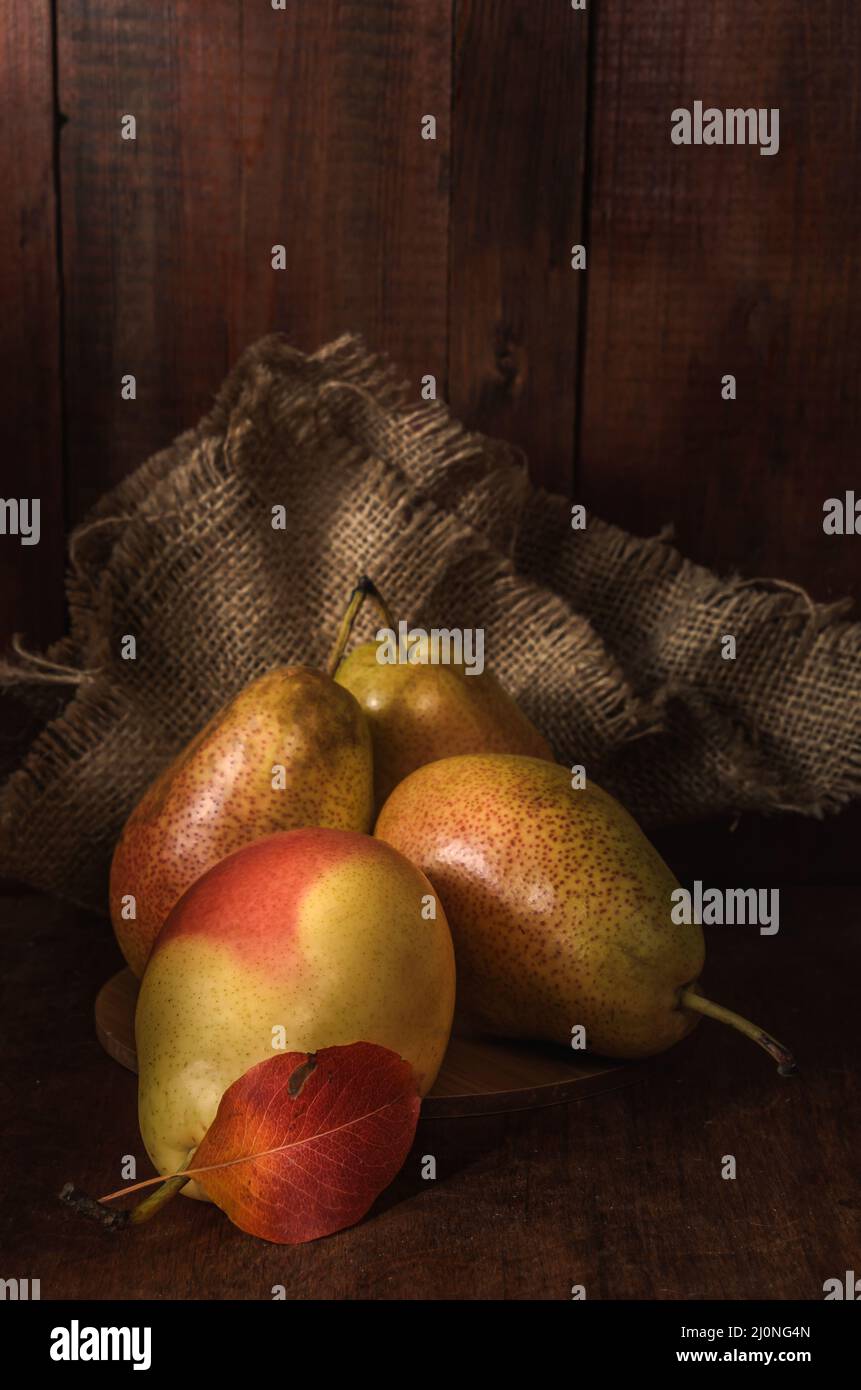 Ripe pears on a dark wooden background in a rustic style Stock Photo